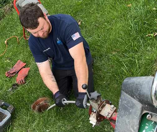 plumber performing a sewer rodding service in brookfield.