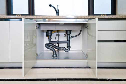 a kitchen with sink drain issues.