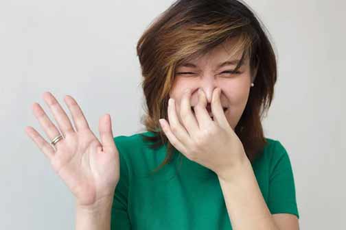 a woman with smelly drain odors.