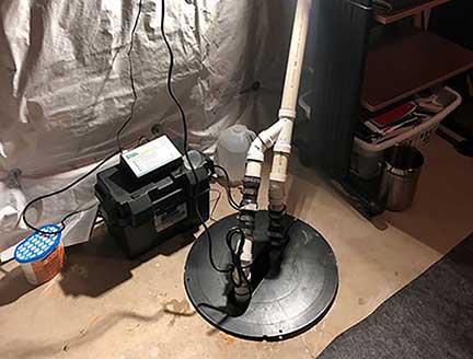 Sump pump installation in Orland Park Illinois showing waterproofing and drainage system setup