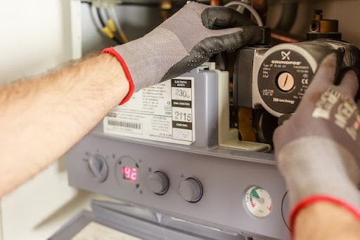 a plumber fixing the sump pump power supply.