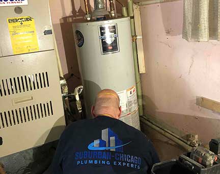Water heater repair in Chicago Illinois with technician servicing hot water system