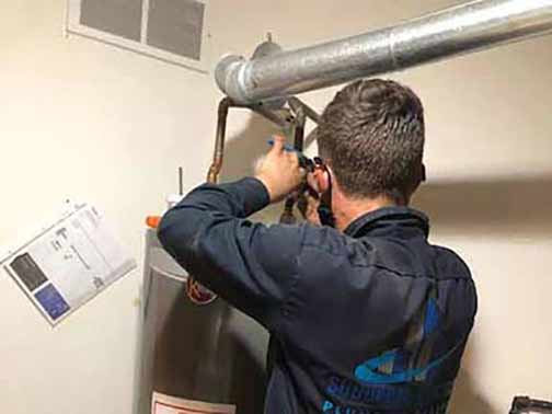 a plumber making water heater repairs.