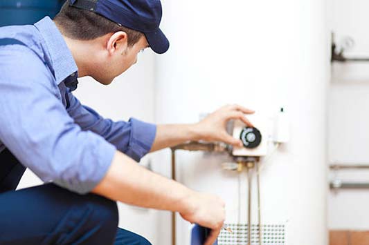 a plumber performing a new water heater installation in brookfield il.