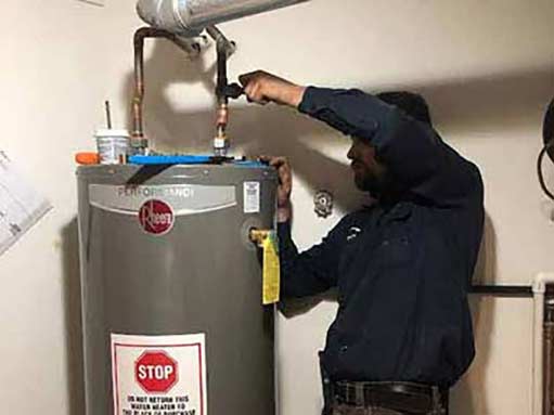 a plumber performing a water heater replacement in willowbrook illinois.