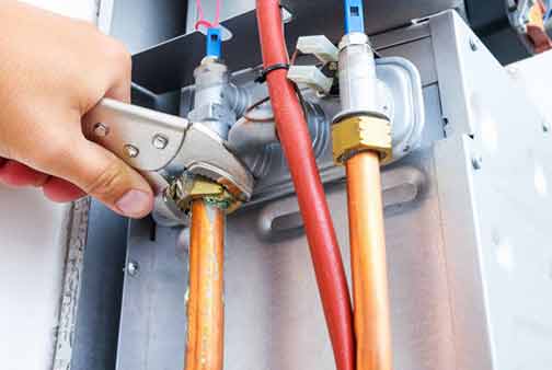 a plumber performing water heater repair services.