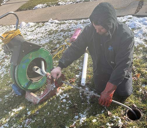 a plumber peforming a sewer line cleaning in orland park