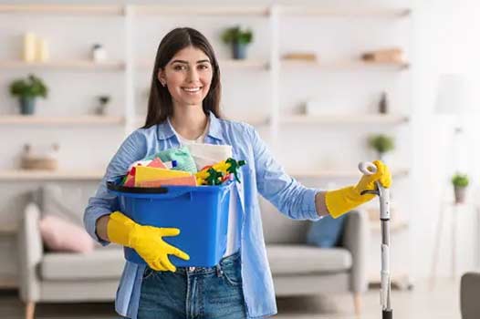 a woman cleaning up before a plumber arrives.